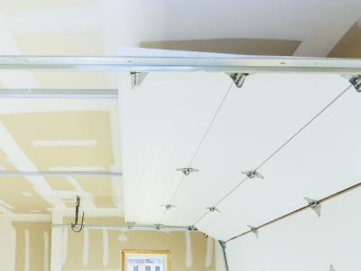 A white, paneled garage door with small, square windows along the top